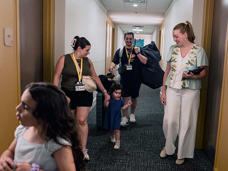 A family walks down the hallway